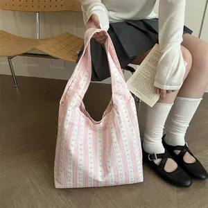 Gentle pink and white striped tote bag with bow details for daily commuting