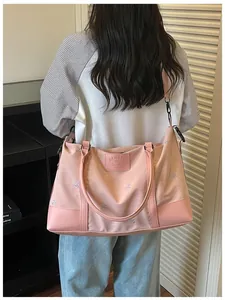 A pink lightweight large capacity expandable travel bag being worn by a model for travel