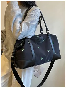 Large capacity black travel bag with green bow embroidery and adjustable strap