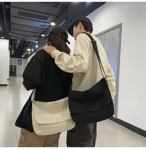 Minimalist large capacity canvas messenger bags in black and off-white colors for couples