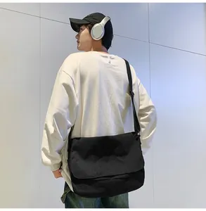 Large capacity black messenger bag for men, casual postman style with adjustable strap.