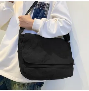 Close-up of black corduroy messenger bag with large capacity utility design
