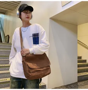 Casual Japanese brown messenger bag worn by male model for trendy urban lifestyle