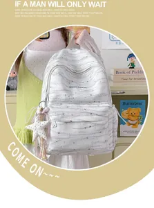 Detailed view of a white tie-dye student backpack shown in a lifestyle setting