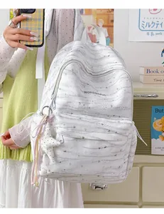 Detailed view of a white tie-dye backpack featuring WONDERFUL print and star charm