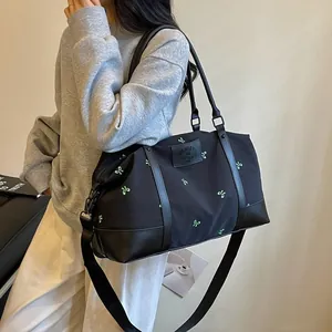 Large black travel duffel bag with green bow embroidery for women's short trips