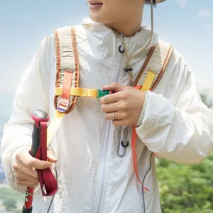 Outdoor-Wanderrucksack mit leuchtenden Farben auf einer weißen Jacke in der Natur gezeigt