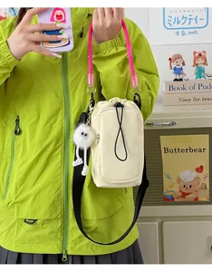Lightweight dopamine style mini crossbody phone bag with pink rope strap and charm.
