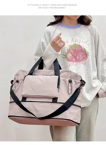 Lifestyle view of large capacity pink travel duffle bag carried by model for gym usage