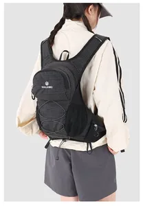 Detailed back view of a professional outdoor cycling hydration backpack on a model