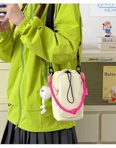 Lightweight beige crossbody phone bag for women with vibrant pink rope strap decoration