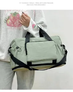 Close-up detail of a light green large capacity gym bag being held by a person