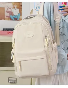 Detailed view of a minimalist cream waterproof backpack for students in a cozy lifestyle setting.