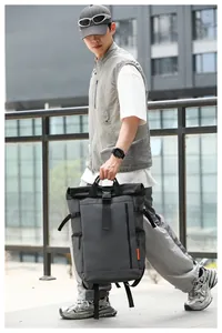 Large capacity gray Oxford cloth backpack for men shown in an urban outdoor setting