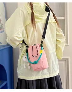 Rear view of a person wearing a pink crossbody phone bag with turquoise rope detail.