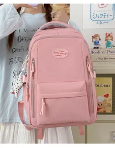 Close-up of pink grid-textured backpack with stylish star charm in a cozy setting