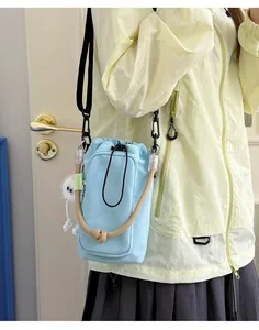 Light blue small dopamine crossbody bag for phone and water bottle detail view
