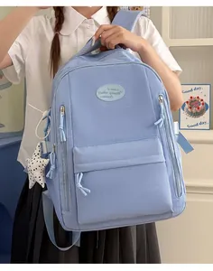 Minimalist light blue student backpack with grid texture and star charm pendant detail