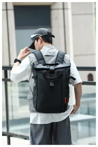 Outdoor lifestyle view of a man wearing a black water-resistant Oxford backpack