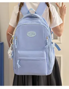 Macro view of light blue minimalist student backpack featuring a subtle grid texture design