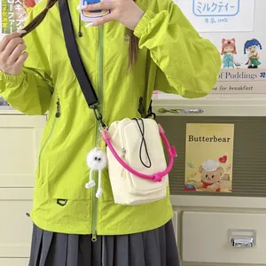 Small dopamine off-white crossbody bag with pink handle and monster keychain