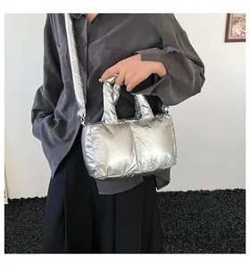 Fashionable silver metallic padded tote bag with crossbody strap for casual wear