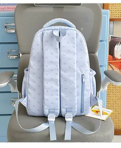 Back view of light blue school backpack with butterfly print and side zipper pocket