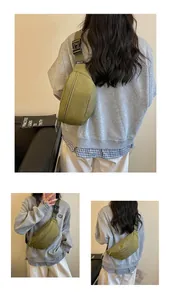Styling details of olive green chest bag, showcasing versatile wearing ways for women