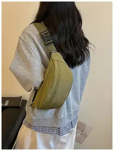 Fashionable green crossbody sling bag for women featuring minimalist high street style