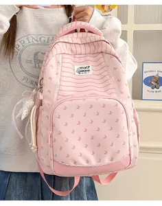 Detailed view of pink student backpack with butterfly patterns and striped accents