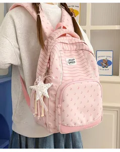 Stylish pink striped student backpack with cute butterfly patterns and a star plush charm