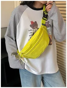 Model wearing a bright neon yellow street style chest bag with casual sporty outfit