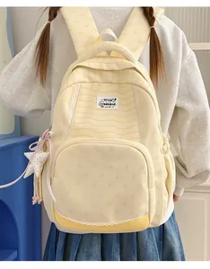 Stylish yellow striped backpack for students featuring a star charm and lace detail.