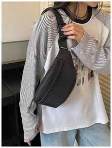 Minimalist black high-street style waist bag shown on model for casual daily use and travel