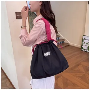 Large capacity foldable waterproof drawstring shopping bag shown on an Asian model