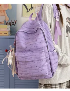 Close-up detail of a light purple tie-dye student backpack with heart patterns and star charm