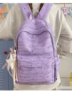 Close-up of lavender tie-dye backpack showing butterfly patterns and star ornament detail