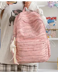 Detailed view of a stylish pink tie-dye backpack featuring a cute star-shaped pendant