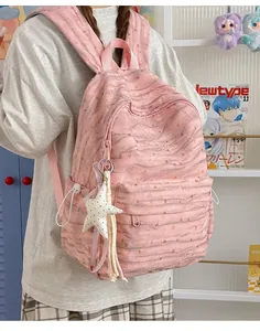 Pink tie-dye backpack for school with a star pendant, lifestyle detail view