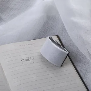 Close-up view of a professional wooden fountain pen ink blotter stamp tool on notebook