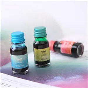 Close-up detail of blue green and pink glass ink bottles for fountain pen gift sets