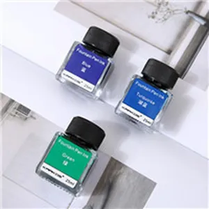 Detail view of three 25ml fountain pen ink bottles in blue, turquoise, and green colors