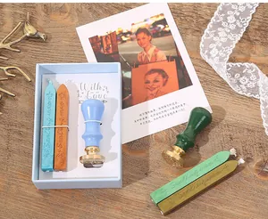 Detailed view of European vintage sealing wax set with colorful wax sticks and wooden stamps.