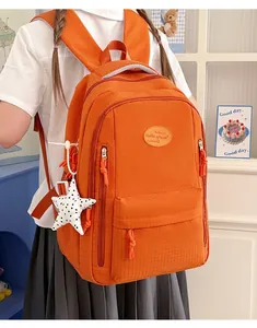 Side view showing multiple zipper compartments of orange water-resistant backpack