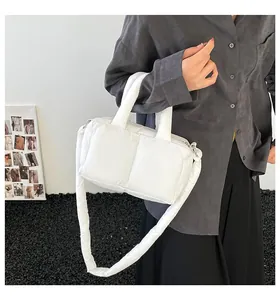 Fashionable white quilted puffer shoulder tote bag shown in a casual lifestyle outfit