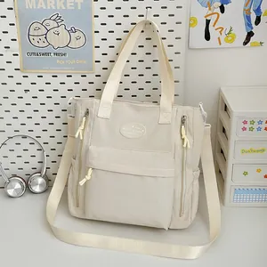 Large capacity Japanese-style beige canvas tote bag with multiple pockets for daily school use