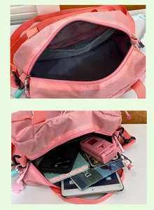 Detailed view of the large capacity pink crossbody bag interior with mesh storage pocket