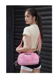 Detailed lifestyle view of a pink outdoor sports crossbody bag worn by a young model