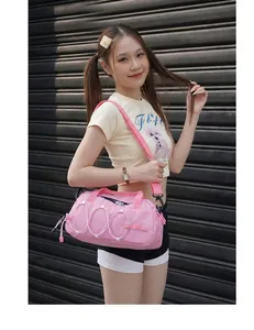 Fashionable model wearing a pink outdoor sports crossbody bag with bungee cord details