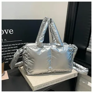 Silver metallic padded puffer handbag with top handles and matching shoulder strap